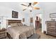 Spacious main bedroom features a rustic wood bed frame and access to the bathroom at 21141 E Stirrup St, Queen Creek, AZ 85142
