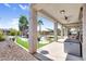 Spacious covered patio overlooks the landscaped backyard, complete with pool and lounge area at 21141 E Stirrup St, Queen Creek, AZ 85142