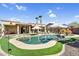 Relaxing backyard featuring a pool with a spa and an outdoor dining set with umbrellas at 21141 E Stirrup St, Queen Creek, AZ 85142