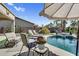 A beautiful pool with lounge chairs and patio seating offers a tranquil outdoor retreat at 21141 E Stirrup St, Queen Creek, AZ 85142