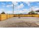Large backyard with desert landscaping, a wooden fence, and some stone paver accents at 2161 E Corona Ave, Phoenix, AZ 85040