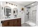 Elegant bathroom with double sinks, modern fixtures, and a walk-in shower at 2161 E Corona Ave, Phoenix, AZ 85040