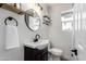 Cozy bathroom with modern fixtures, round mirror and dark wood cabinet at 2161 E Corona Ave, Phoenix, AZ 85040