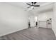 Bright bedroom showcasing brick wall design and ceiling fan, leading to the bathroom at 2161 E Corona Ave, Phoenix, AZ 85040