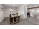 A dining room showcasing a rustic wooden table and views of the open-concept kitchen at 2161 E Corona Ave, Phoenix, AZ 85040