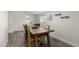 Dining area featuring a wooden table and a sliding glass door leading to the backyard at 2161 E Corona Ave, Phoenix, AZ 85040