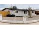 Street view showing a white one-story home with gravel landscaping and a newly installed white picket fence at 2161 E Corona Ave, Phoenix, AZ 85040