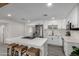 Clean kitchen featuring a central island with bar seating, white cabinets, and stainless steel appliances at 2161 E Corona Ave, Phoenix, AZ 85040