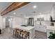 Modern white kitchen featuring an island with barstool seating and stainless steel appliances at 2161 E Corona Ave, Phoenix, AZ 85040
