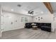 Spacious living room with a large sofa, ceiling fan, and decorative wooden beam at 2161 E Corona Ave, Phoenix, AZ 85040