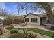Landscaped backyard with desert plants, a fire pit, a ping pong table, and pavers for outdoor living at 2544 W Pumpkin Ridge Dr, Anthem, AZ 85086