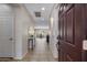 Bright foyer featuring tile flooring, neutral walls, console table, and view into dining and living area at 2544 W Pumpkin Ridge Dr, Anthem, AZ 85086