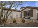 A charming front entrance with tiled patio, desert landscaping, and a wrought-iron gate at 2544 W Pumpkin Ridge Dr, Anthem, AZ 85086