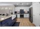 Modern kitchen with white cabinets, stainless steel appliances, and a stylish blue backsplash at 2544 W Pumpkin Ridge Dr, Anthem, AZ 85086