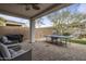 Covered patio with comfortable seating, ping pong table, and a grill, great for relaxing and entertaining at 2544 W Pumpkin Ridge Dr, Anthem, AZ 85086