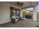 The covered patio has ceiling fan and cozy seating, plus a grill, ideal for outdoor relaxation and dining at 2544 W Pumpkin Ridge Dr, Anthem, AZ 85086