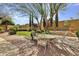 Lush backyard with outdoor dining area, spa, and mature landscaping creates a serene retreat at 28689 N 67Th Dr, Peoria, AZ 85383