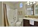 Well-lit bathroom with shower-tub, white countertop, and a dark vanity at 28689 N 67Th Dr, Peoria, AZ 85383