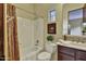 Bathroom features a shower-tub combination with brown vanity and decorative mirror at 28689 N 67Th Dr, Peoria, AZ 85383