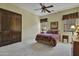 This bedroom shows a beautiful decorative area rug, sliding wood doors, and plush window coverings at 28689 N 67Th Dr, Peoria, AZ 85383