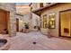 Picturesque courtyard with stone accents, fireplace, potted plants, and architectural details under a twilight sky at 28689 N 67Th Dr, Peoria, AZ 85383