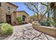 Charming courtyard with stone pathway, lush landscaping, and architectural details, perfect for outdoor enjoyment at 28689 N 67Th Dr, Peoria, AZ 85383