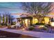 Inviting single-Gathering home featuring a landscaped front yard and a charming covered entryway with stone accents at 28689 N 67Th Dr, Peoria, AZ 85383