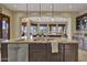 Spacious kitchen island features a stainless steel dishwasher and granite countertops at 28689 N 67Th Dr, Peoria, AZ 85383