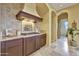 Well-equipped kitchen featuring custom cabinetry, granite countertops, tiled backsplash, and stainless steel appliances at 28689 N 67Th Dr, Peoria, AZ 85383