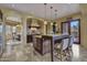 Gourmet kitchen with a center island, breakfast bar, pendant lighting, and seamless access to the dining area at 28689 N 67Th Dr, Peoria, AZ 85383