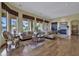 Spacious living room featuring hardwood floors, a cozy fireplace, and large windows offering abundant natural light at 28689 N 67Th Dr, Peoria, AZ 85383