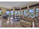 Elegant living area with ample seating, stylish decor, and seamless transition to the outdoor pool area at 28689 N 67Th Dr, Peoria, AZ 85383