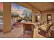 Outdoor patio with elegant seating area, fountain and view of pool and well-maintained landscaping at 28689 N 67Th Dr, Peoria, AZ 85383