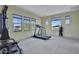 Spacious workout room with a treadmill, weight rack, and many windows with mountain views at 28689 N 67Th Dr, Peoria, AZ 85383
