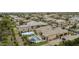 Resort-style backyard with pool, basketball court, lush landscaping, and a covered patio offers the ultimate in outdoor living and entertainment at 3314 E Kael St, Mesa, AZ 85213
