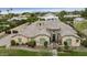 Aerial view of a charming home with desert landscaping, a tile roof, and lush greenery at 3314 E Kael St, Mesa, AZ 85213