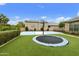 A spacious backyard features a basketball court and trampoline, providing endless fun and entertainment for the whole Gathering at 3314 E Kael St, Mesa, AZ 85213