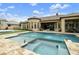 An expansive backyard boasts a sparkling pool, spa, and lush landscaping, perfect for outdoor living and entertaining at 3314 E Kael St, Mesa, AZ 85213