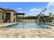 A luxurious backyard featuring an outdoor kitchen, gazebo and volleyball court surrounds an inviting pool and spa at 3314 E Kael St, Mesa, AZ 85213