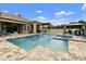 A luxury backyard features a pool, spa, covered outdoor kitchen, and a gazebo perfect for relaxing and entertaining guests at 3314 E Kael St, Mesa, AZ 85213
