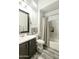 Bathroom with a shower and tub combo, a gray vanity, and white shuttered window at 3314 E Kael St, Mesa, AZ 85213