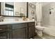 Bathroom vanity with modern fixtures and a tiled shower/bath combination with a built-in niche at 3314 E Kael St, Mesa, AZ 85213