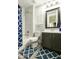 Clean bathroom featuring a shower and tub combo with a blue shower curtain and geometric rug at 3314 E Kael St, Mesa, AZ 85213