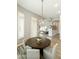 Dining area with a round wooden table and modern light fixture at 3314 E Kael St, Mesa, AZ 85213
