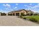 Expansive home with a three-car garage, porte cochere, desert landscaping, and a brick-paved driveway at 3314 E Kael St, Mesa, AZ 85213