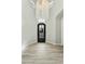 Elegant foyer with a statement chandelier and wrought iron door at 3314 E Kael St, Mesa, AZ 85213