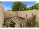 Charming backyard garden area with raised beds, wooden fence, and lush greenery, creating tranquil space at 3314 E Kael St, Mesa, AZ 85213