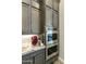 Kitchen featuring stainless steel appliances, custom cabinets, and tile backsplash at 3314 E Kael St, Mesa, AZ 85213