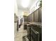 Well-lit laundry room with washer, dryer, dark wood cabinets, and a closet beyond at 3314 E Kael St, Mesa, AZ 85213