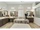 Luxurious bathroom with a soaking tub, double vanity, framed mirrors, and natural light at 3314 E Kael St, Mesa, AZ 85213